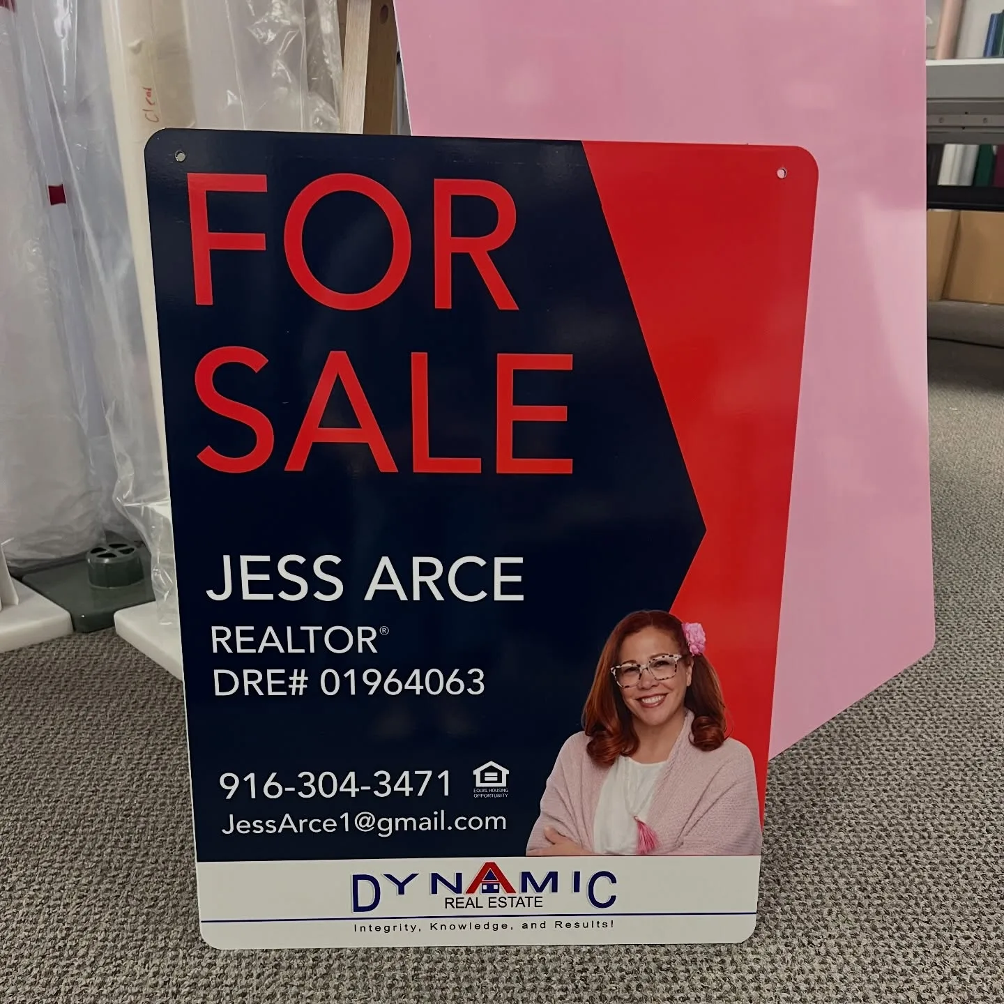 A finished navy-and-red aluminum 'FOR SALE' real-estate panel sign for realtor Jess Arce of Dynamic Real Estate, with her headshot photo